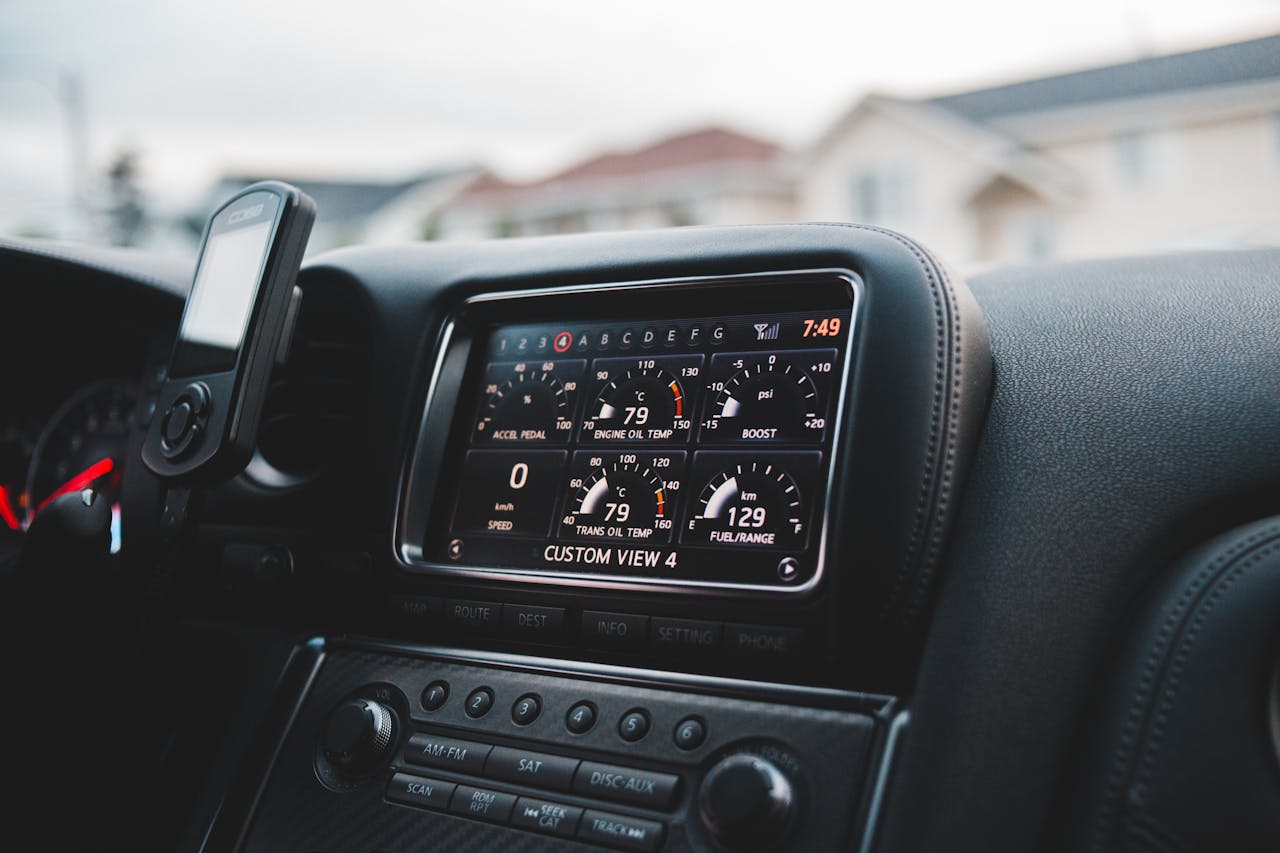 Close-up of a luxury car's digital dashboard with a sleek design and leather interior.